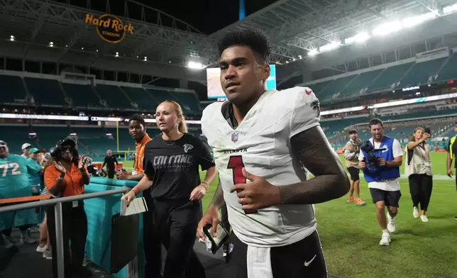 Atlanta Falcons quarterback Tua Tagovailoa (1) jogs off the field after an NFL preseason football game against the Miami Dolphins, Friday, Aug. 28, 2026, in Miami Gardens, Fla. (AP Photo/Lynne Sladky)