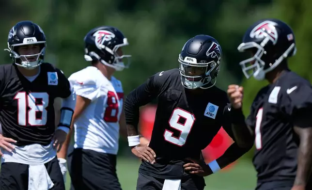 Atlanta Falcons quarterbacks Michael Penix Jr. (9) Jack Strand (18) and Tua Tagovailoa (1) run drills during an NFL football training camp practice Monday, Aug. 24, 2026, in Flowery Branch, Ga. (AP Photo/Brynn Anderson)