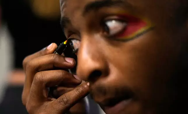 Circus performer Brian Ngobese applies makeup as he prepares for his appearance in The Cirk’s “Worlds Away” show in Johannesburg, Friday, Aug. 28, 2026. (AP Photo/Themba Hadebe)