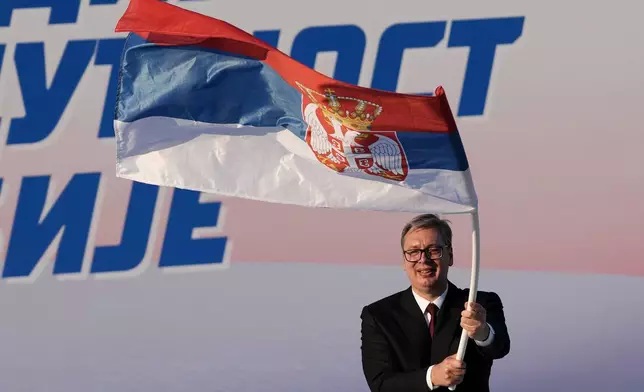 FILE - Serbian President Aleksandar Vucic waves a Serbian flag during a rally of the ruling Serbian Progressive Party (SNS) in Belgrade, Serbia, on June 27, 2026. (AP Photo/Darko Vojinovic, File)