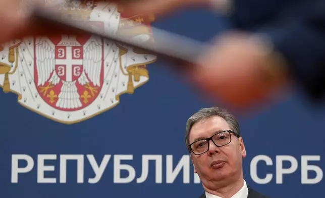 FILE - Serbian President Aleksandar Vucic looks on as documents are exchanged after the signing of an agreement following talks with Azerbaijan President Ilham Aliyev at the Serbia Palace in Belgrade, Serbia, Feb. 15, 2026. (AP Photo/Darko Vojinovic, File)