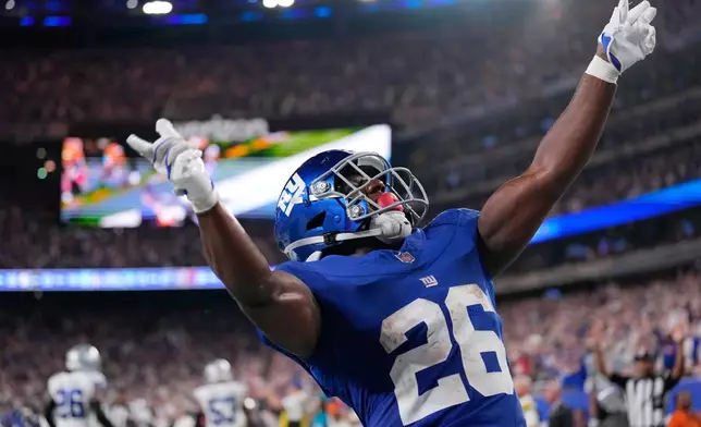 New York Giants running back Devin Singletary reacts after scoring a touchdown against the Dallas Cowboys during the second half of an NFL football game Sunday, Sept. 13, 2026, in East Rutherford, N.J. (AP Photo/Yuki Iwamura)