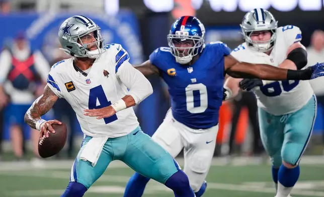 Dallas Cowboys quarterback Dak Prescott (4) looks to pass as New York Giants linebacker Brian Burns (0) gets by the block of Cowboys' TJ Bass (66) during the first half of an NFL football game Sunday, Sept. 13, 2026, in East Rutherford, N.J. (AP Photo/Yuki Iwamura)