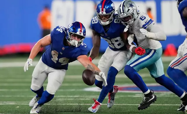 New York Giants running back Cam Skattebo (44) tries to recover his fumble as teammate wide receiver Malachi Fields (88) and Dallas Cowboys linebacker Donovan Ezeiruaku (6) try to get to the ball during the second half of an NFL football game Sunday, Sept. 13, 2026, in East Rutherford, N.J. (AP Photo/Yuki Iwamura)