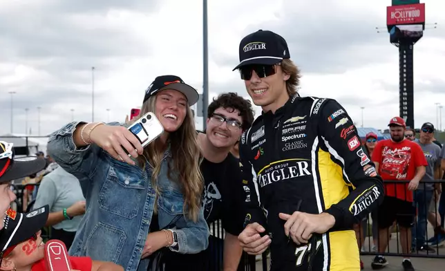 Carson Hocevar, right, interacts with fans before a NASCAR Cup Series auto race in Kansas City, Kan., Sunday, Sept. 27, 2026. (AP Photo/Colin E. Braley)