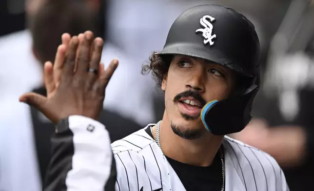 Chicago White Sox's Miguel Vargas celebrates with teammates in the dugout after scoring on a Munetaka Murakami single during the first inning of a baseball game against the Detroit Tigers Saturday, Sept. 19, 2026, in Chicago. (AP Photo/Paul Beaty)