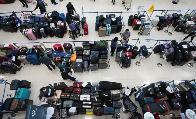 Rows of undelivered luggage are placed in the arrivals hall at Suvarnabhumi International Airport in Samut Prakan, Thailand, Tuesday, Sept. 29, 2026, after heavy rain and floods in Bangkok prevent airport workers from getting to work. (AP Photo/Sakchai Lalit)