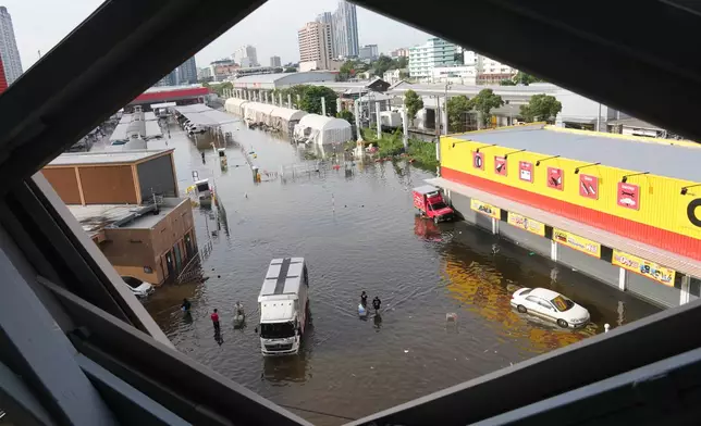 Streets are flooded after heavy rain in Bangkok, Thailand, Tuesday, Sept. 29, 2026. (AP Photo/Sakchai Lalit)