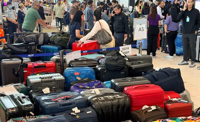 In this photo made from smartphone, rows of undelivered luggage are placed in the arrivals hall at Suvarnabhumi International Airport in Bangkok, Thailand, Tuesday, Sept. 29, 2026, after flooding affected operations. (AP Photo/Celine Rosario)