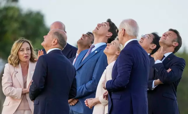 FILE -- From right, French President Emmanuel Macron, Japan's Prime Minister Fumio Kishida, U.S. President Joe Biden, European Commission President Ursula von der Leyen, Canada's Prime Minister Justin Trudeau, Britain's Prime Minister Rishi Sunak, European Council President Charles Michel, German Chancellor Olaf Scholz and Italian Prime Minister Giorgia Meloni watch a skydiving demo during the G7 world leaders summit at Borgo Egnazia, Italy, Thursday, June 13, 2024. (AP Photo/Luca Bruno, File)
