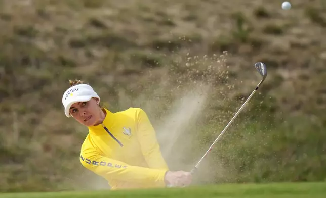 Charley Hull of Europe plays from a bunker near the 8th green during the Solheim Cup in Den Bosch, Netherlands, Saturday, Sept. 12, 2026. (AP Photo/Alastair Grant)