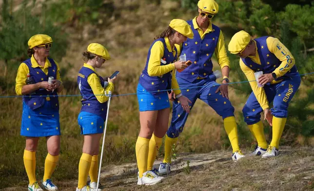 Europe supporters stand along the course on day two of the Solheim Cup in Den Bosch, Netherlands, Saturday, Sept. 12, 2026. (AP Photo/Alastair Grant)