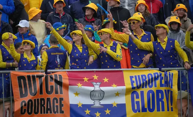 Europe fans gather in the rain on the 1st tee on the final day of the Solheim Cup in Den Bosch, Netherlands, Sunday, Sept. 13, 2026. (AP Photo/Alastair Grant)