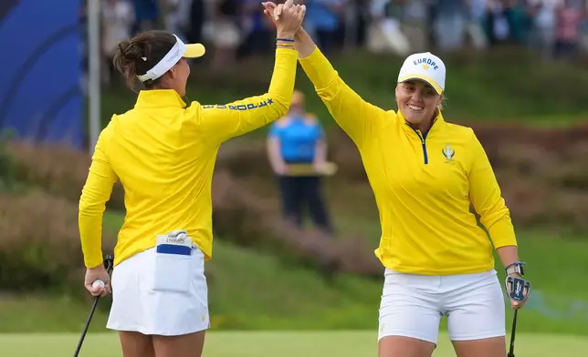 Maja Stark, right, and Linn Grant of Europe celebrate after putting on the 15th green during the Solheim Cup in Den Bosch, Netherlands, Saturday, Sept. 12, 2026. (AP Photo/Alastair Grant)