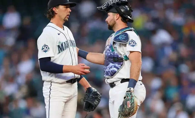Seattle Mariners pitcher Logan Gilbert (36) speaks with catcher Cal Raleigh (29) in the first inning of a baseball game against the Houston Astros, Tuesday, Sept. 22, 2026, in Seattle. (AP Photo/Kevin Ng)