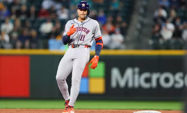 Houston Astros right fielder Cam Smith (11) reacts after hitting a double in the second inning of a baseball game against the Seattle Mariners, Tuesday, Sept. 22, 2026, in Seattle. (AP Photo/Kevin Ng)
