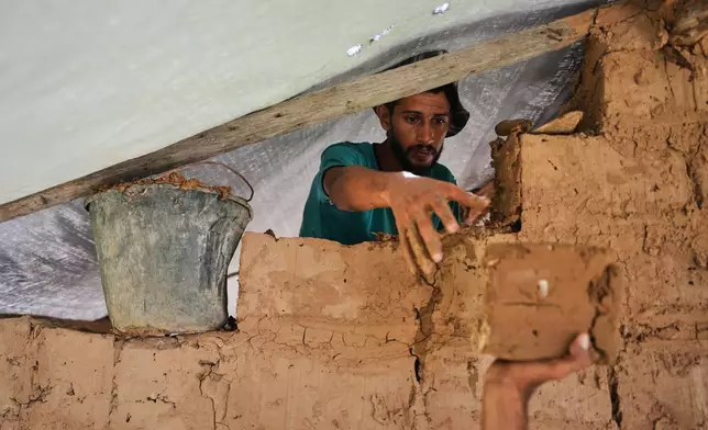 Palestinians build a room with mud bricks as an alternative amid a shortage of construction supplies in the Gaza Strip, in Nuseirat, Saturday, Sept. 5, 2026. (AP Photo/Abdel Kareem Hana)