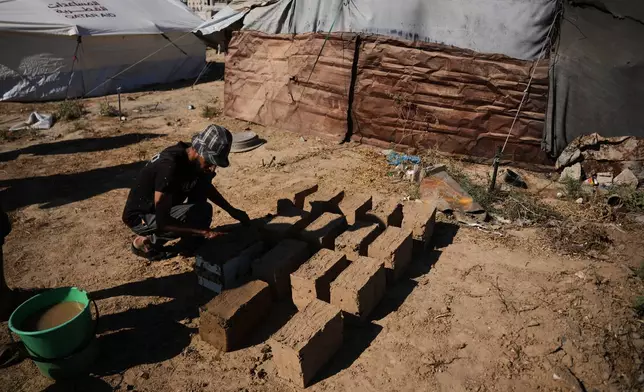 Khalil Abu Deeb, 31, makes clay bricks for building a house amid a shortage of construction materials in the Gaza Strip, in the Maghazi refugee camp, central Gaza Strip, Thursday, Sept. 3, 2026. (AP Photo/Abdel Kareem Hana)