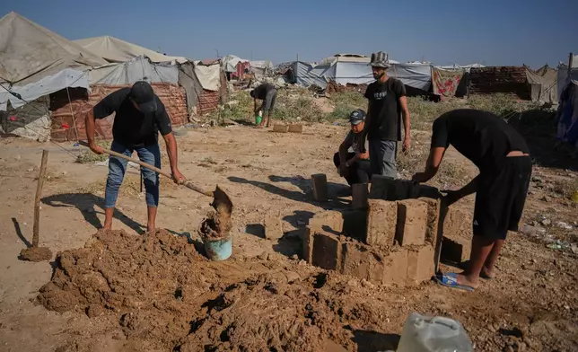 Palestinians make clay bricks for building amid a shortage of construction materials in the Gaza Strip, in the Maghazi refugee camp, central Gaza Strip, Thursday, Sept. 3, 2026. (AP Photo/Abdel Kareem Hana)