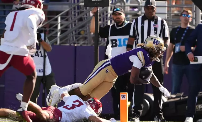 Washington wide receiver Rashid Williams scores a touchdown past Washington State defensive back Jaylen Thomas during the second half of an NCAA college football game, Sunday, Sept. 6, 2026, in Seattle. (AP Photo/Lindsey Wasson)