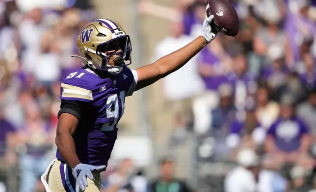 Washington defensive end Isaiah Ward reacts after recovering a fumble against Washington State during the first half of an NCAA college football game, Sunday, Sept. 6, 2026, in Seattle. (AP Photo/Lindsey Wasson)
