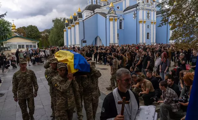 Ukrainian servicemen carry the coffin of fallen soldier Danyil Smyrnov, 21, who was killed on the frontline, during the funeral ceremony in Kyiv, Ukraine, Thursday, Sept. 3, 2026. (AP Photo/Alex Babenko)
