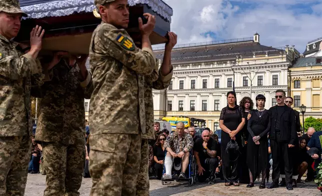 Family and friends pay their respects to soldier Danyil Smyrnov, 21, who was killed on the frontline, during his funeral ceremony in Kyiv, Ukraine, Thursday, Sept. 3, 2026. (AP Photo/Alex Babenko)