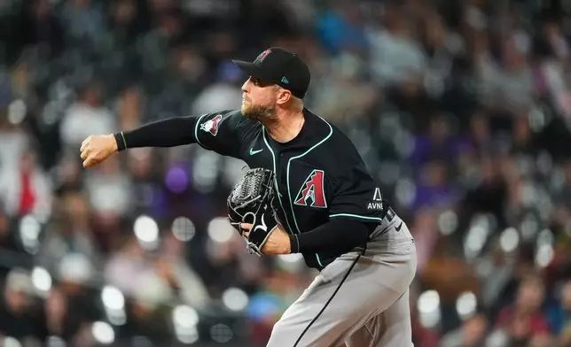 Arizona Diamondbacks starting pitcher Merrill Kelly works against the Colorado Rockies in the second inning of a baseball game Wednesday, Sept. 23, 2026, in Denver. (AP Photo/David Zalubowski)