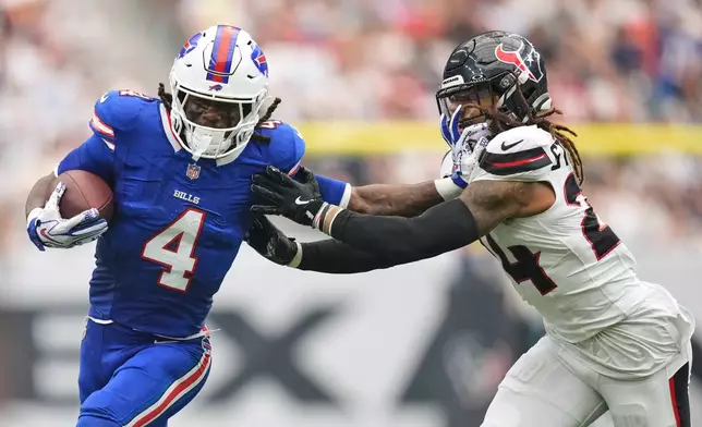 Buffalo Bills running back James Cook III (4) is tackled by Houston Texans cornerback Derek Stingley Jr., right, during the first half of an NFL football game, Sunday, Sept. 13, 2026, in Houston. (AP Photo/Ashley Landis)