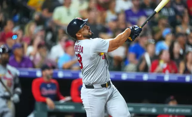 St. Louis Cardinals' Iván Herrera watches his three-run home run off Colorado Rockies relief pitcher Jordan Romano in the ninth inning of a baseball game Friday, Sept. 4, 2026, in Denver. (AP Photo/David Zalubowski)