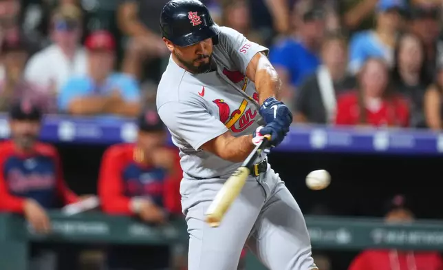 St. Louis Cardinals' Iván Herrera connects for a three-run home run off Colorado Rockies relief pitcher Jordan Romano in the ninth inning of a baseball game Friday, Sept. 4, 2026, in Denver. (AP Photo/David Zalubowski)