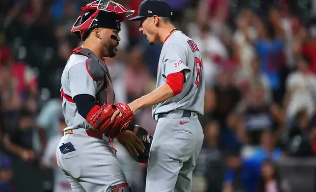 St. Louis Cardinals catcher Leo Bernal, left, congratulates relief pitcher Riley O'Brien, right, after a baseball game against the Colorado Rockies, Friday, Sept. 4, 2026, in Denver. (AP Photo/David Zalubowski)