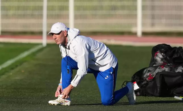 France national soccer team coach Zinedine Zidane ties his shoes during a training session in Clairefontaine-en-Yvelines west of Paris, Tuesday, Sept. 22, 2026, three days ahead of France's UEFA Nations League soccer match against Turkey. (AP Photo/Thibault Camus)