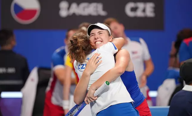 Czech Republic's Linda Noskova smiles and hugs a member of her team as they celebrate her victory against Spain's Cristina Bucsa in the Billie Jean King Cup women's singles semifinal between Spain and Czech Republic, in Shenzhen, China, Friday, Sept. 25, 2026. (AP Photo/Andy Wong)