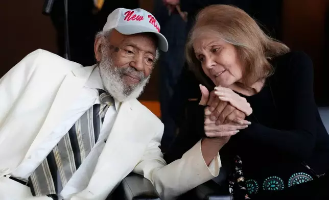 FILE - Political activist James Meredith, left, holds hands with social activist, writer and editor Gloria Steinem at The Medgar and Myrlie Evers Institute Courage and Justice Gala, commemorating the 60th anniversary of the 1963 assassination of Medgar Evers in Jackson, Miss., on June 9, 2023. (AP Photo/Rogelio V. Solis, File)