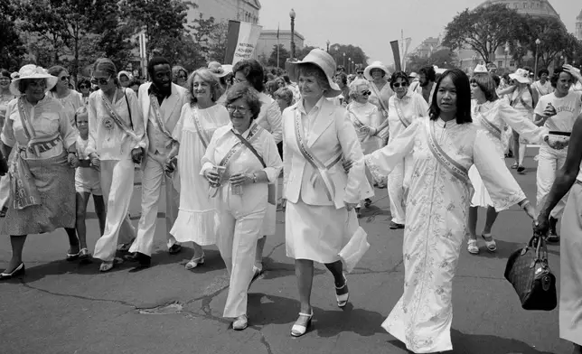 FILE - Leading supporters of the Equal Rights Amendment march in Washington, July 9, 1978, urging Congress to extend the time for ratification of the ERA. From left are: Gloria Steinem; Dick Gregory; Betty Friedan; Rep. Elizabeth Holtzman, D-N.Y. (partially obscured); Rep. Barbara Mikulski, D-Md.; and Rep. Margaret Heckler, R-Mass. The women at far left and right are unidentified. (AP Photo/Dennis Cook, File)