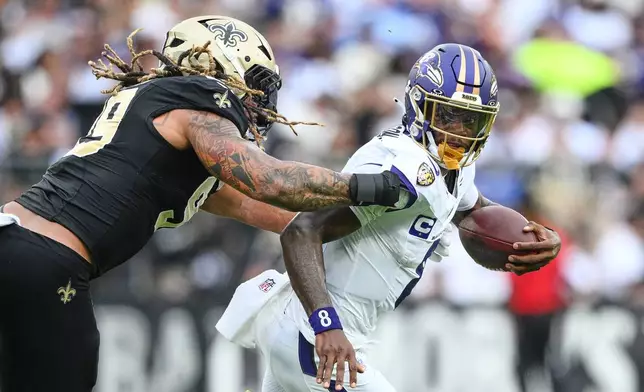 Baltimore Ravens quarterback Lamar Jackson is sacked by New Orleans Saints defensive end Chase Young (99) in the second half of an NFL football game in Baltimore, Sunday, Sept. 20, 2026. (AP Photo/Nick Wass)