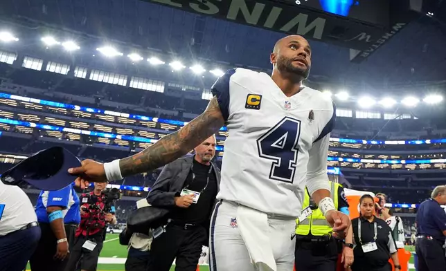 Dallas Cowboys quarterback Dak Prescott (4) leaves the field after an NFL football game against the Washington Commanders in Arlington, Texas, Sunday, Sept. 20, 2026. (AP Photo/Julio Cortez)