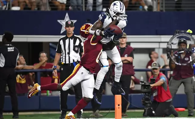 Dallas Cowboys wide receiver Ceedee Lamb (88) makes a catch to score a touchdown against Washington Commanders cornerback Mike Sainristil (0) in the second half during an NFL football game in Arlington, Texas, Sunday, Sept. 20, 2026. (AP Photo/Jessica Tobias)