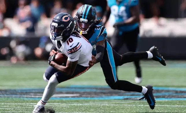 Carolina Panthers cornerback Will Lee III (24) tackles Chicago Bears wide receiver Luther Burden III (10) during the first half of an NFL football game, Sunday, Sept. 13, 2026, in Charlotte, N.C. (AP Photo/Scott Kinser)
