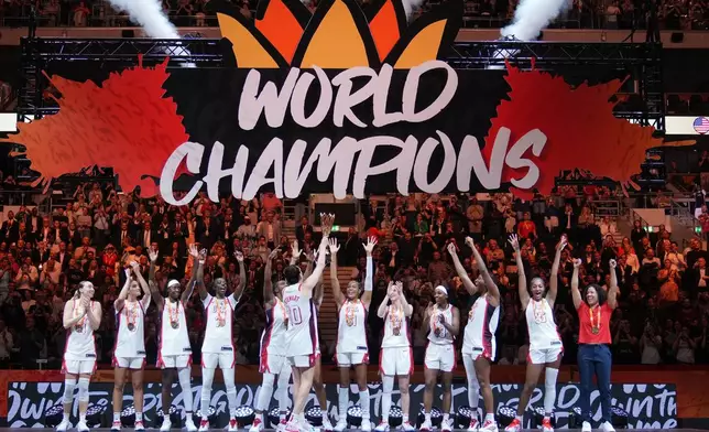 United States team stands on the podium after winning the Women's Basketball World Cup final match between the United States and France in Berlin, Sunday, Sept. 13, 2026. (AP Photo/Ebrahim Noroozi)