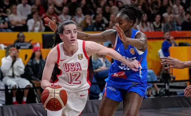 France's Mamignan Toure guardcs Caitlin Clark of the United States, during the Women's Basketball World Cup final match between the United States and France in Berlin, Sunday, Sept. 13, 2026. (AP Photo/Ebrahim Noroozi)
