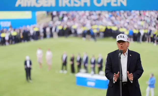 U.S. President Donald Trump speaks prior to presenting the winners trophy to Shane Lowry of Ireland during the Irish Open golf tournament at Trump International Golf Links in Doonbeg, Ireland, Sunday, Sept. 13, 2026. (AP Photo/Julia Demaree Nikhinson)
