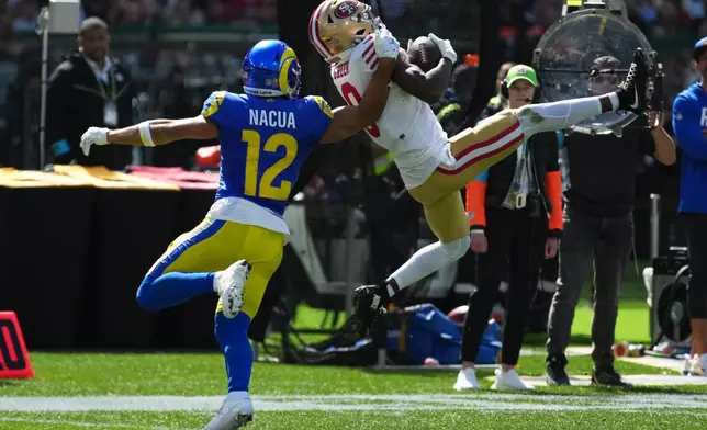 San Francisco 49ers cornerback Renardo Green intercepts of pass intended for Los Angeles Rams wide receiver Puka Nacua during the first half of an NFL football game, Friday, Sept. 11, 2026, in Melbourne, Australia. (AP Photo/Asanka Brendon Ratnayake)
