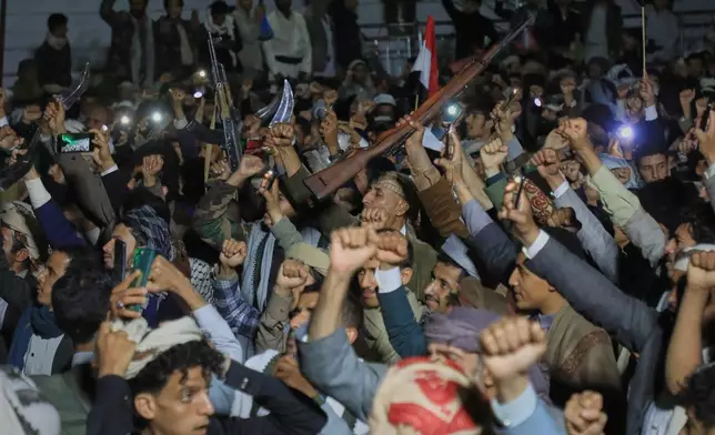 Supporters of Yemen's Houthi rebels raise rifles and their fists during a rally organized to celebrate the group's capture of Mayun Island in the strategic Bab el-Mandeb Strait, in Houthi-controlled Sanaa, Yemen, Friday, Sept. 11, 2026. (AP Photo/Osamah Abdulrahman)