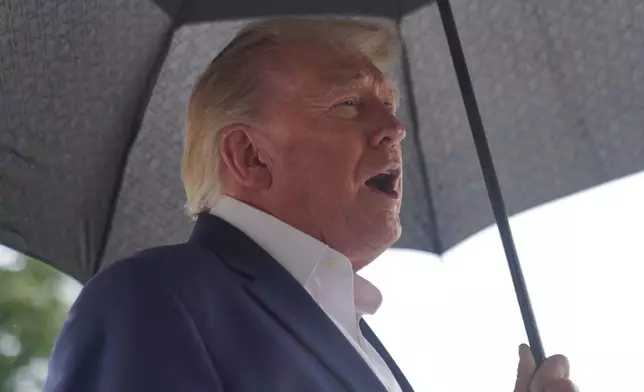 President Donald Trump talks to reporters on the South Lawn of the White House before boarding Marine One, Sunday, Sept. 27, 2026, in Washington. (AP Photo/Allison Robbert)