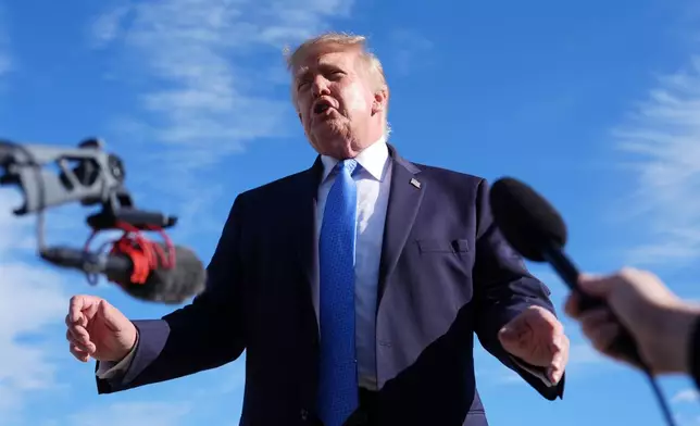 President Donald Trump speaks with reporters upon arriving at Chicago O'Hare International Airport, Sunday, Sept. 27, 2026, in Chicago. (AP Photo/Julia Demaree Nikhinson)