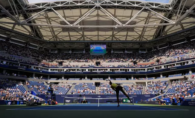 Elena Rybakina, of Kazakhstan, follows through on a serve to Qinwen Zheng, of China, during the quarterfinal round of the U.S. Open tennis championships, Wednesday, Sept. 9, 2026, in New York. (AP Photo/Seth Wenig)