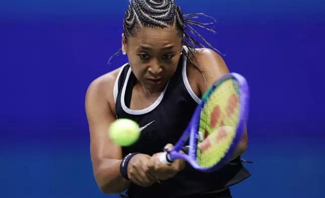 Naomi Osaka, of Japan, returns the ball to Anastasia Zakharova, of Russia, during the first round of the U.S. Open tennis championships Monday, Aug. 31, 2026, in New York. (AP Photo/Adam Hunger)