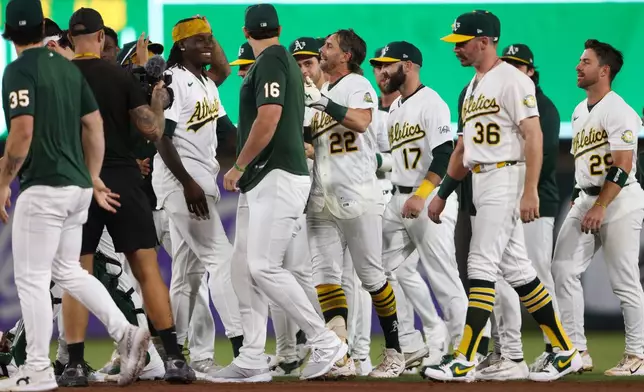 Athletics' Jeff McNeil (22) celebrates with his teammates after hitting a walk off RBI single during the ninth inning of a baseball game against the Toronto Blue Jays Monday, Sept. 7, 2026, in West Sacramento, Calif. (AP Photo/Scott Marshall)